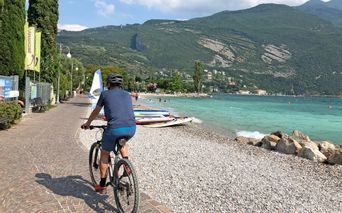 Cyclists on the lake shore in Riva del Garda